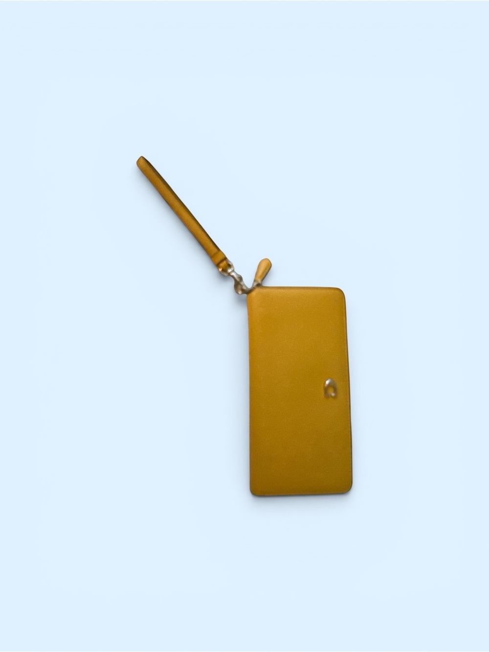 Large Coach marigold yellow clutch with wrist strap.